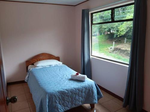 a bedroom with a bed and a window at Globi Lodge #5 in Monteverde Costa Rica