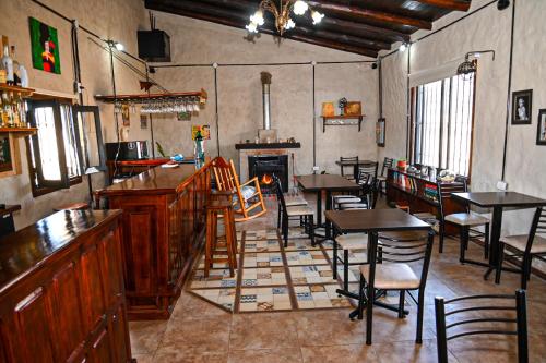 a restaurant with tables and chairs and a fireplace at Posada Casablanca in La Carolina