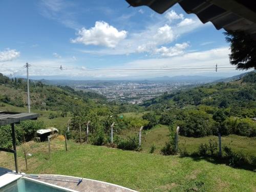a view of a valley from a house with a swimming pool at FINCA LA FORTALEZA in Santa Rosa de Cabal