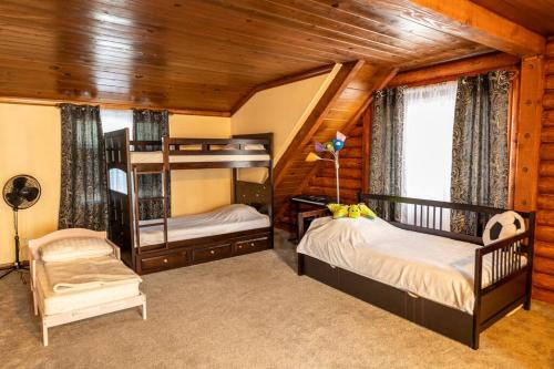 a bedroom with two bunk beds and a chair at Family House in Pine Mountain Club
