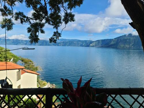 a view of a lake from a house at Hotel Restaurante La Villa de los Dioses in San Antonio Palopó