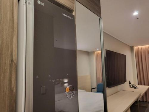 a bathroom with a glass door leading to a bedroom at Hotel SUMMIT in Gwangju