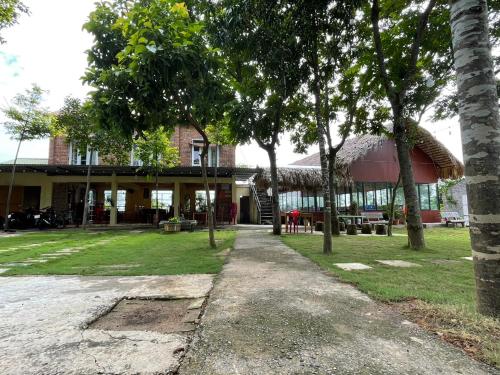 a building with trees in front of it at Cuc Phuong Bungalow in Phủ Nho Quan