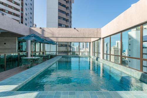 a swimming pool on the roof of a building at Flat de luxo Rooftop 201 in Recife