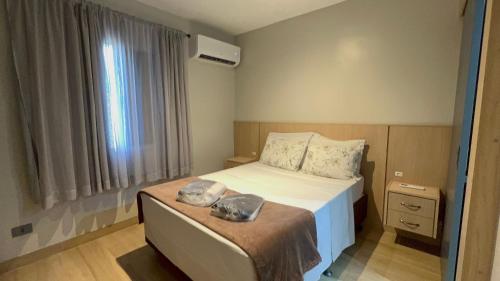 a bedroom with a bed and a window at Flat Saint Paul Jardim Paulista Magnifico! in Sao Paulo