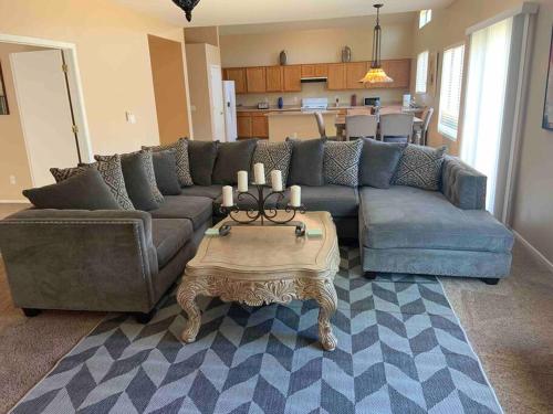 a living room with a couch and a table at Bella Oasis Family Retreat in El Mirage