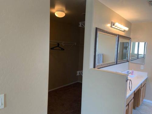 a bathroom with a sink and a mirror at Bella Oasis Family Retreat in El Mirage