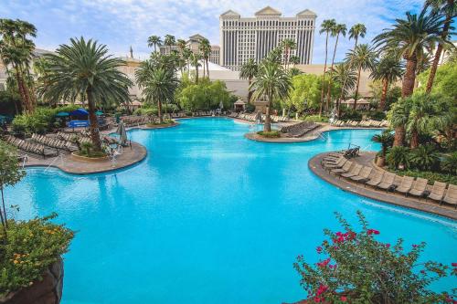 a pool with blue water in a resort at Restful Unit at Mirage Casino Strip Las Vegas in Las Vegas