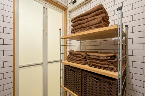 a towel rack in a bathroom with towels at Total 107square meter 4min to nearest staion Max16pp in Tokyo