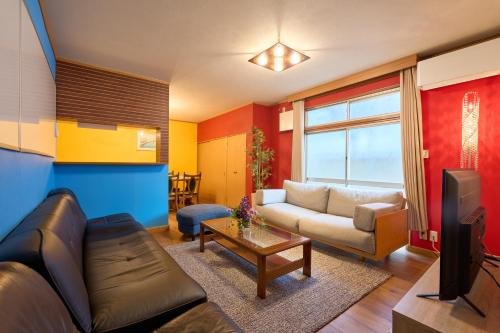 a living room with a couch and a tv at Total 107square meter 4min to nearest staion Max16pp in Tokyo
