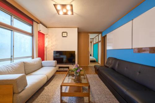 a living room with a couch and a tv at Total 107square meter 4min to nearest staion Max16pp in Tokyo