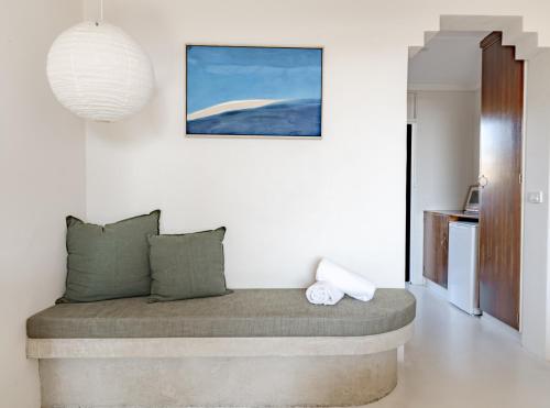 a bed in a room with a white wall at Hillcrest Merimbula in Merimbula