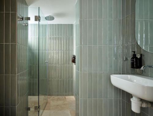 a bathroom with a sink and a glass shower at Oxford House in Sydney