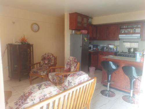 een keuken met 2 stoelen, een tafel en een aanrecht bij Sea View Guest Accommodation in Roseau
