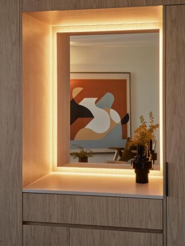a mirror on a wall with a vase on a shelf at Oxford House in Sydney