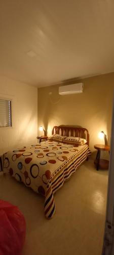 a bedroom with a large bed with a polka dot blanket at Cabañas Don Tatin in La Banda