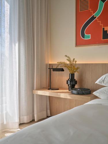 a bedroom with a bed and a table with a plant at Oxford House in Sydney