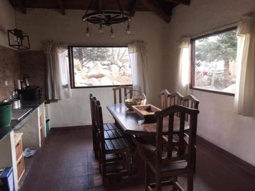a kitchen with a table and chairs in a room at PORTAL DE LA OVEJERIA in Tafí del Valle
