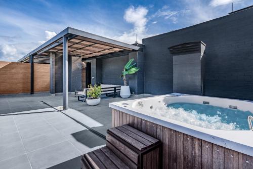 a jacuzzi tub in the backyard of a house at Olive Living Suites by HOUSY HOST in Envigado