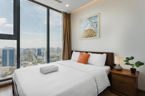 Ένα ή περισσότερα κρεβάτια σε δωμάτιο στο Shendo Vinhomes Metropolis