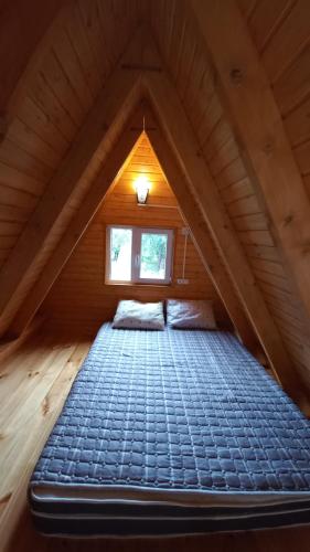a bed in the attic of a log cabin at Sionis Idilia in Sioni