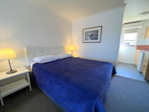 Ένα ή περισσότερα κρεβάτια σε δωμάτιο στο Summerhill Motor Inn