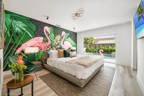 a bedroom with a large mural of pink flamingos at Flamingo's Resort in Miami