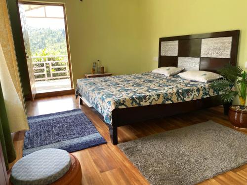a bedroom with a bed and a window at The Nature House Village Homestay in Mukteswar
