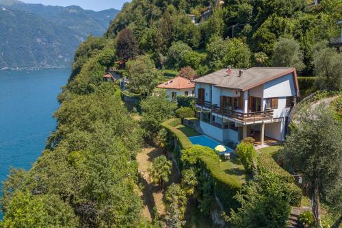 an aerial view of a house on a hill next to the water at Villa Marilyn in Nesso