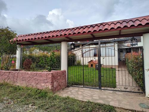 a gate to a house with a fence at Hospedaje Las Golondrinas - Tibirita, Cundinamarca in Tibirita