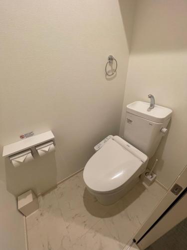 a bathroom with a white toilet in a room at The Grand Residence Hotel Tenjin in Fukuoka
