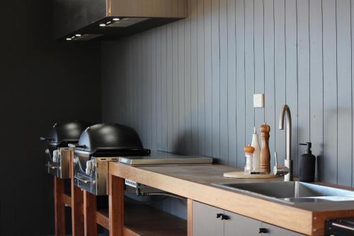 a kitchen with a sink and a counter top at Pebbly Beach Escape in East Lynne