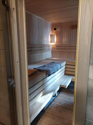 an inside of a sauna with a bed in it at Pirts Jaunakmeni in Priežmale