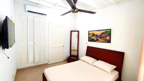 sypialnia z łóżkiem i wentylatorem sufitowym w obiekcie Happy tours apartments w mieście Cartagena de Indias