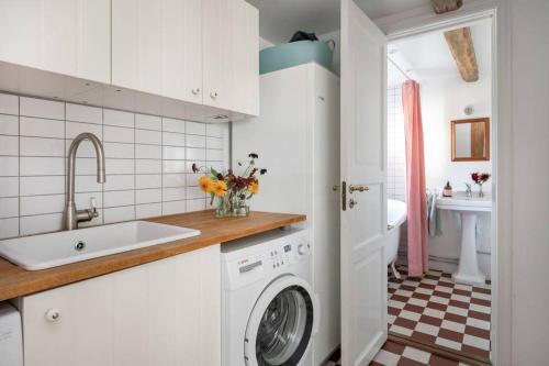 a kitchen with a washing machine and a sink at Farmhouse in Sweden 15 minutes from Malmö in Trelleborg