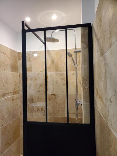 a shower with a glass door in a bathroom at Rêve en Lubéron in Lauris