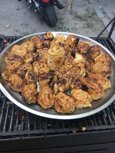 a pan of food on top of a grill at Old House Gyumri in Gyumri
