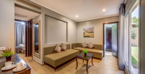 a living room with a couch and a table at Daria- Authentic Israeli Experience in Samra