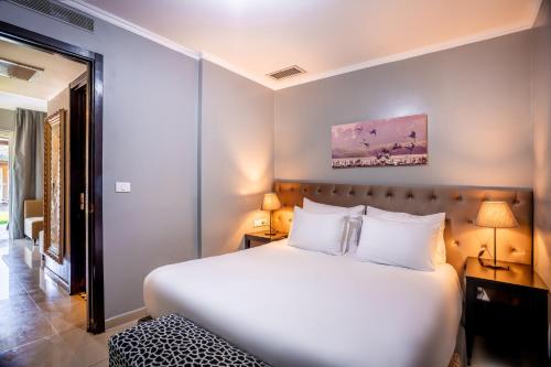 a bedroom with a large white bed and a window at Daria- Authentic Israeli Experience in Samra