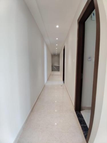 an empty corridor with a mirror in a room at Hotel Utsav Grand in Varanasi