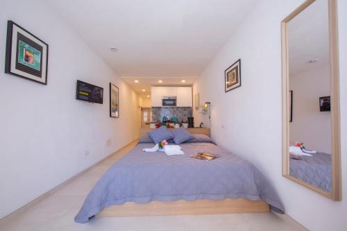 a bedroom with a bed and a large mirror at Colonno Fronte Lago in Colonno