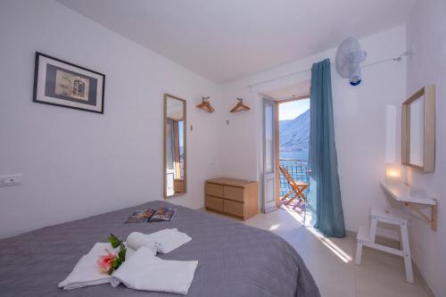 a bedroom with a bed and a window with a view at Colonno Fronte Lago in Colonno