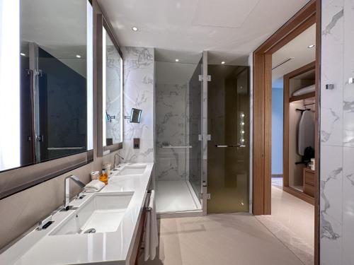 a bathroom with two sinks and a shower at Luxury 3-bedroom apartment with a stunning view of the Burj Khalifa and the Fountain in Dubai