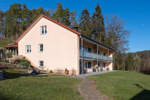 a large white house with a lawn in front of it at Ferienwohnungen Dormann 