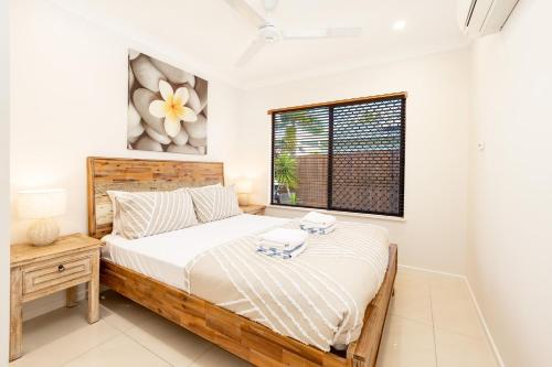 a bedroom with a bed and a window at 4BR Smithfield Serenity; Pool, BBQ & Pool Table in Smithfield