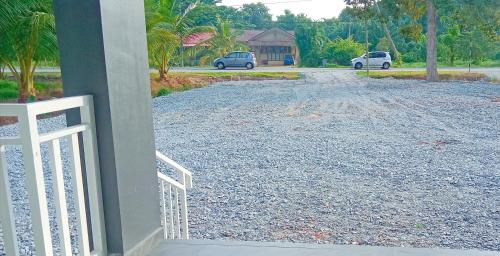 a view of a driveway from a house with a gate at Homestay Asam Pedas Parit Jawa Muar in Bakar Parit