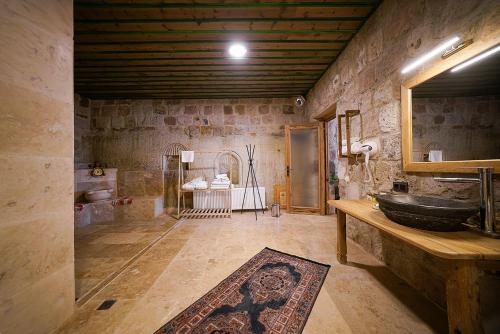 a large bathroom with a sink and a mirror at Serene Premium Stone House in Nevsehir