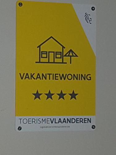 a yellow sign on a door with four stars at Marina Mercator in Ostend