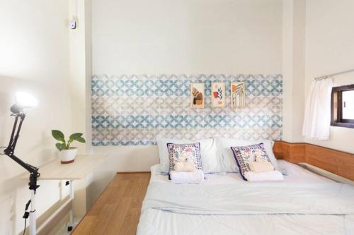 a small bedroom with a white bed with pillows at Teras Sabin in Ngabean