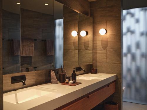 a bathroom with a sink and a mirror at BASK Gili Meno in Gili Meno